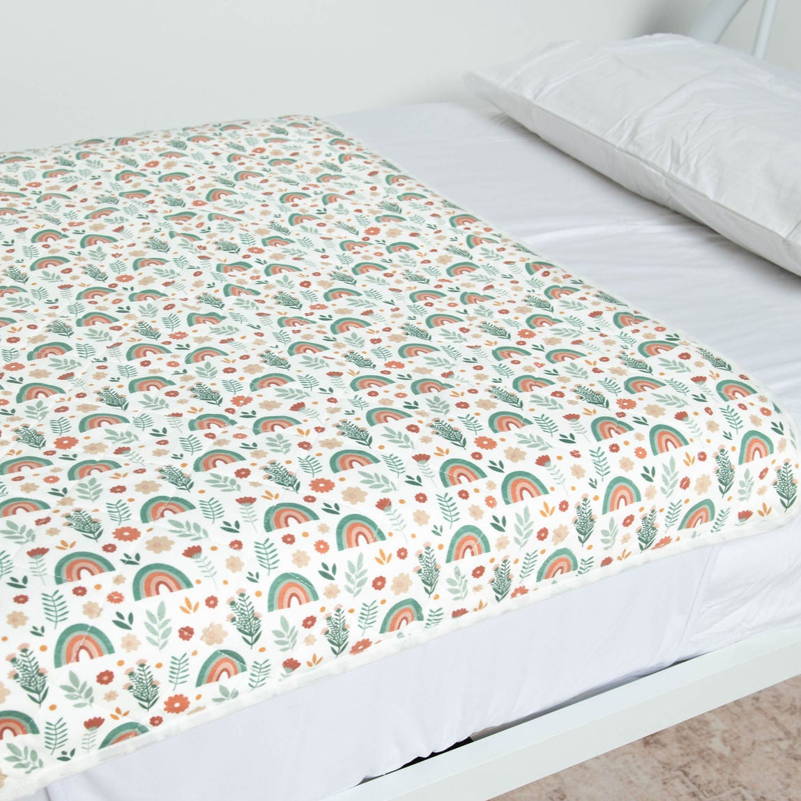 Close up of the Chasing Rainbows pattern on a Bed Mat