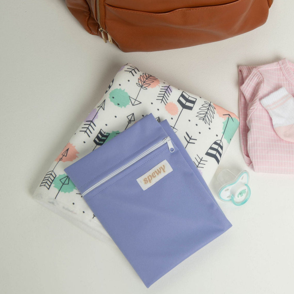 
                      
                        A flat lay of a Polka Arrows Spewy, with a Purple Wetbag placed on top, showing that it's the perfect product to take with you on the go. 
                      
                    