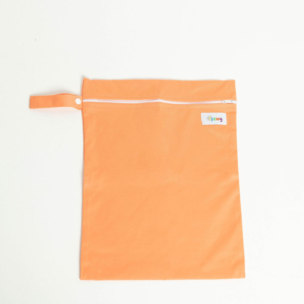 
                      
                        Orange laundry bag with a white zipper on a light gray background
                      
                    